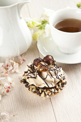 Closeup muffin with vanilla cream and hazelnuts