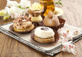 Different sort of beautiful pastry, small colorful sweet cakes w