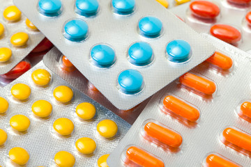 Multicolored pills packed in blisters