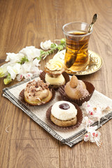Different sort of beautiful pastry, small colorful sweet cakes w
