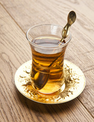 a glass of turkish tea on wooden table