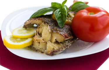 Served grilled fish with lemon