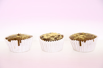 Chocolate muffins.Cupcakes isolated on pink background