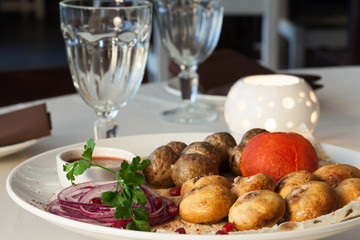 Appetizing dish with potatoes, mushrooms, tomato;