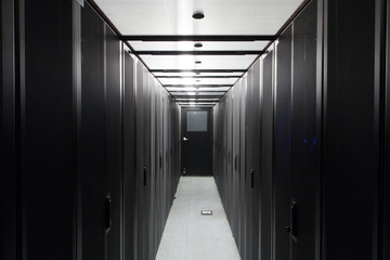 Symmetrically telecommunication racks in sealed corridor.