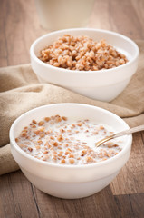 Buckwheat porridge with milk on a wooden table