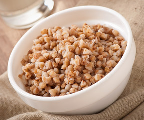 Buckwheat porridge in a bowl on a wooden table