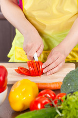 Woman  cut tomatoes