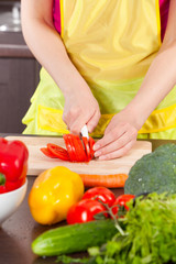 Woman  cut tomatoes