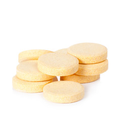 yellow vitamin pills isolated on white