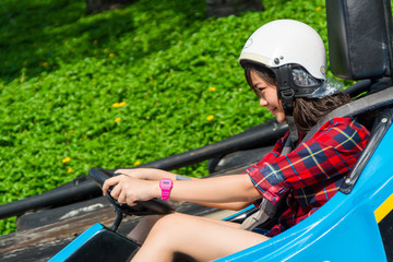 Fototapeta na wymiar Cute Thai girl is driving Go-kart