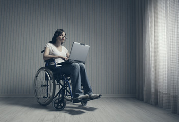 Disabled young woman using laptop