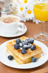 Belgian waffles with blueberries, coffee, orange juice