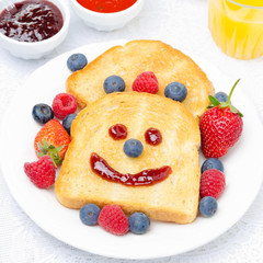 Breakfast with a smiling toast, fresh berries, jams