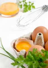 Eggs in a carton and egg yolk