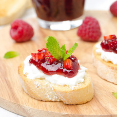 Toasted baguette with cream cheese and raspberry jam