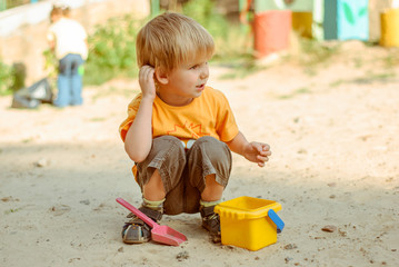 Little  kids play in the sand box © elista