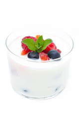 yogurt with different fresh berries in a glass beaker isolated
