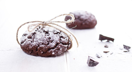 Fresh chocolate cookies on the white wooden background