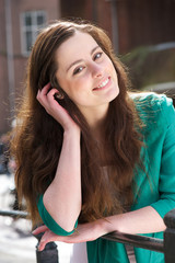 Fototapeta premium Portrat of a friendly young woman looking at camera