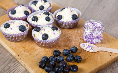 Delicious cupcake with blueberries, cream and fresh berries