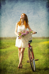 Naklejka na ściany i meble Girl on a bike in the countryside.
