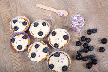Delicious cupcake with blueberries, cream and fresh berries