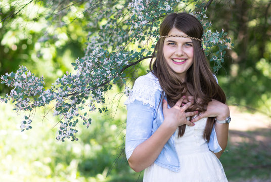 portrait of young lovely woman in spring flowers