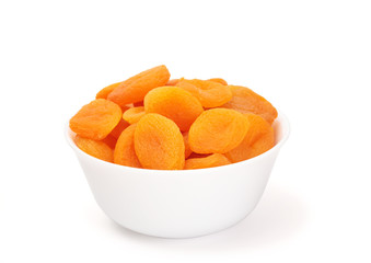 dried apricots in a bowl on white