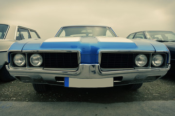 Front of old sport car in blue, sixties style, retro