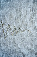 linen background embroider ornament closeup