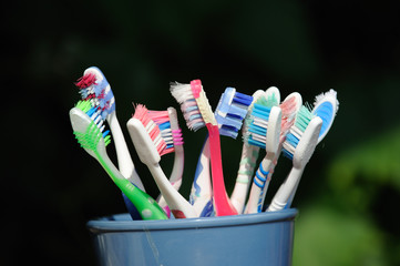 Old toothbrushes in a mug