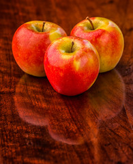 Three Apples on an Old Wooden Table