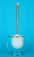 Toilet brush on blue background