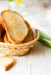 Toasted bread in the bread basket on white boards