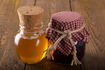 Jars of honey and jam, rustic.