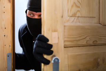 Burglary crime - burglar opening a door