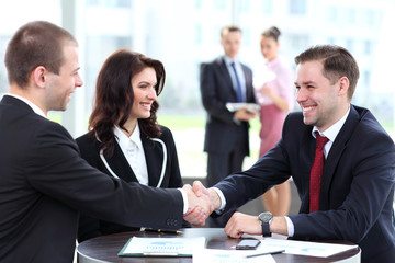 Business people shaking hands, finishing up a meeting