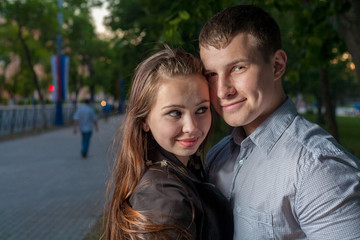Happy young adult couple dancing outdoors at night