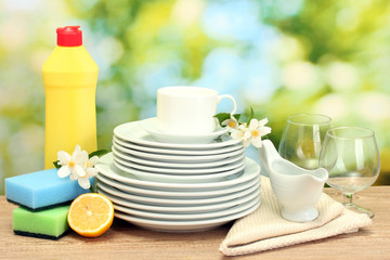empty clean plates, glasses and cups with dishwashing liquid,