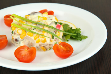 Small portion of food on big plate on wooden table