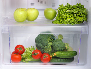 Open refrigerator with vegetarian (diet) food