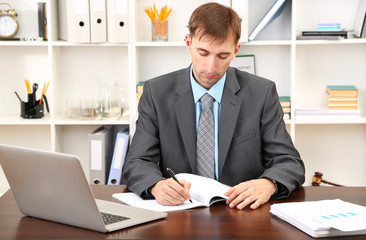 Young businessman in office at his workplace
