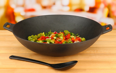 Vegetable ragout in wok, on bright background