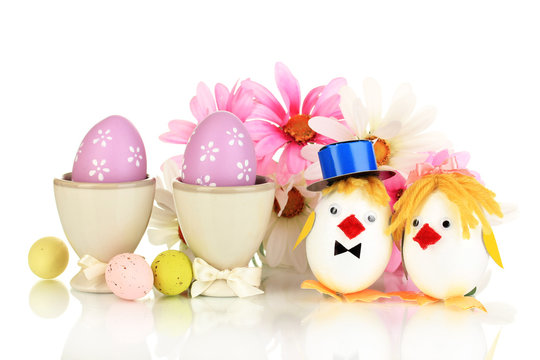 Easter eggs and two chicken toys isolated on white