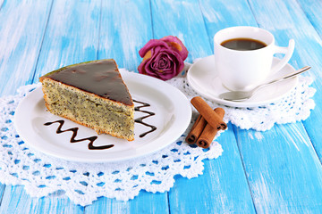 Delicious poppy seed cake with cup of coffee on table close-up