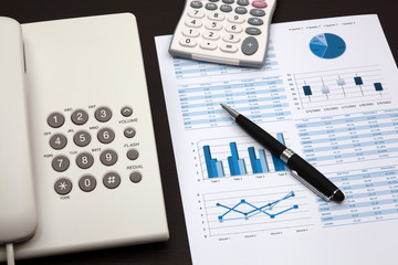 business report with telephone on a table