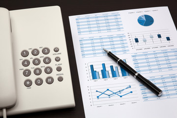 business report with telephone on a table