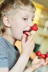 boy is enjoying strawberry