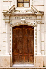 Fototapeta na wymiar brown wood old door of a church capilla san roque